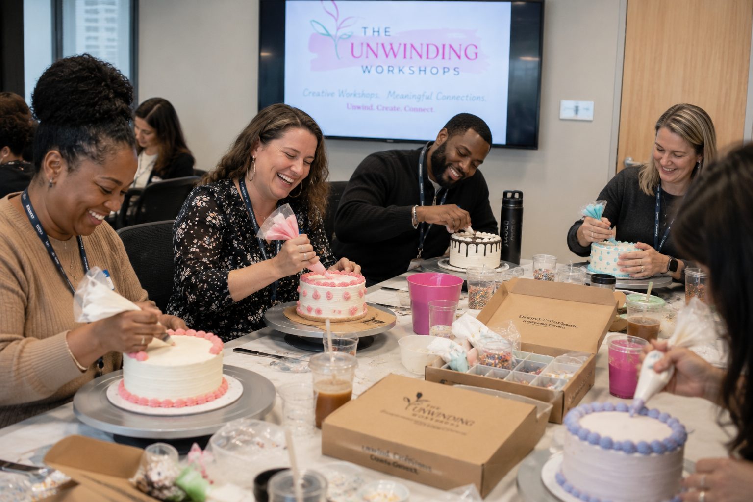 Guests decorating cakes together during a workshop