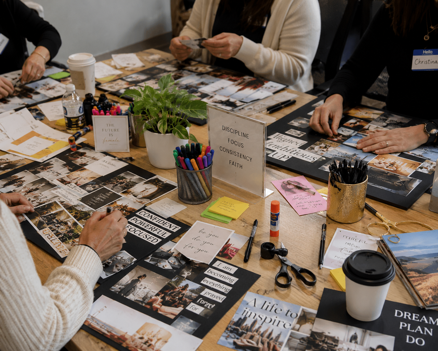 Participants making vision boards with printed images and notes
