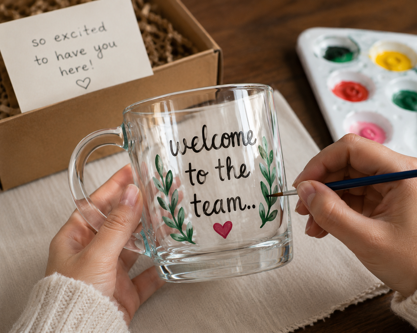 Hand painting a welcome mug for a new team member